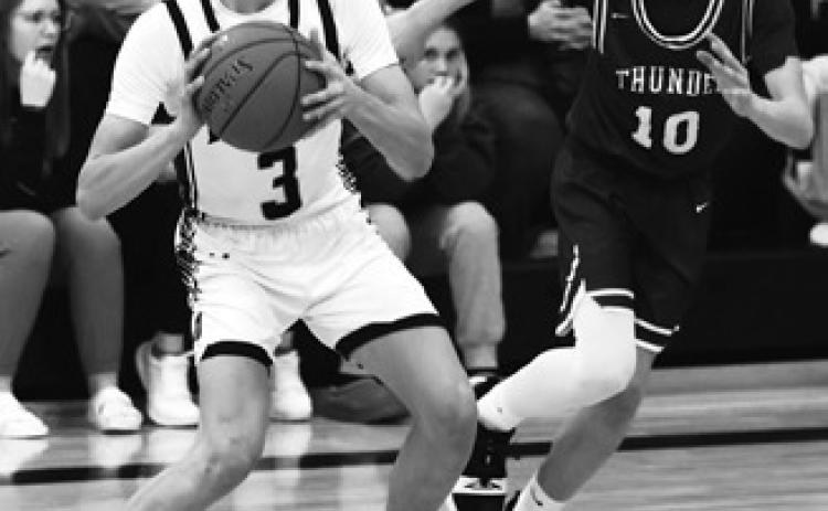 Everett Fedje and Calvin Otto try to stop Hatton-Northwood's Derek Carpenter. Photo by Lyle Van Camp.