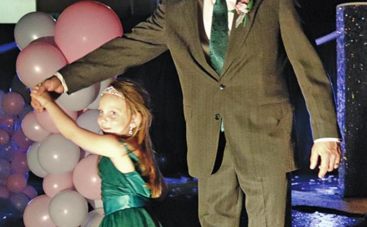 Brooks Stellon give daughter Amelia a twirl during the Grand March for the Daddy Daughter Dance. VNV Photo by Lesa Van Camp