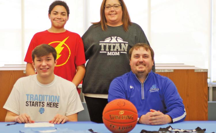 Gage Pollestad poses with his family and Coach following signing his intent to play basketball for Lake Region State College. Pictured front row I to r: Gage Pollestad and Royals Coach Jared Marshell, back row: Mason and Lindsay Pollestad. VNV Photo by Lesa Van Camp