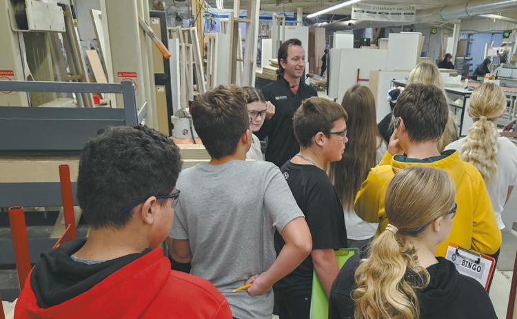 A group of seventh graders toured Woodside Industries in Cavalier and received a behind-the-scenes look from the blueprint and planning stages to the assembly of their custom cabinet systems. Photo by Jamie Rarick