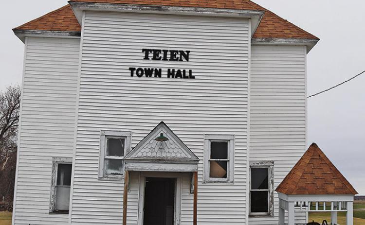 The Teien Town Hall as it currently stands with the bell tower carefully placed on the ground next to the building in an effort to save both the bell and the roof. VNV Photo by Lesa Van Camp