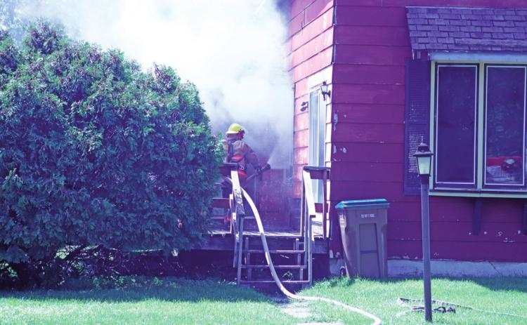 Drayton Volunteer Fire Department works in blistering heat to battle a house fire on Third Street last Friday afternoon.