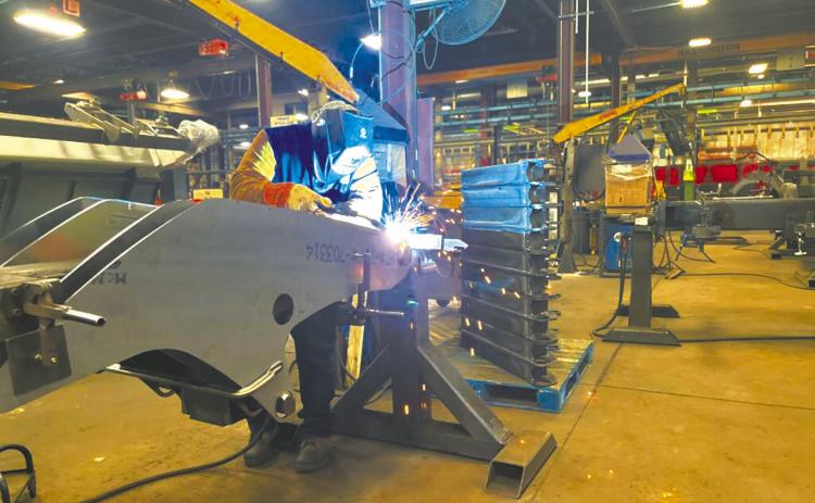 A welder works at a Manitou factory in June 2023 at Madison, South Dakota. Labor shortages in North Dakota and South Dakota could be harbingers of a shortage of young people in coming years. (Photo by Joshua Haiar/South Dakota Searchlight)