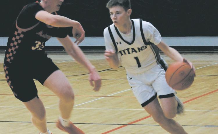 Mustang defender Marek Osowski guards Titan Drew Passa as he moves the ball down the Drayton court Feb. 6. Photo by Jamie Rarick