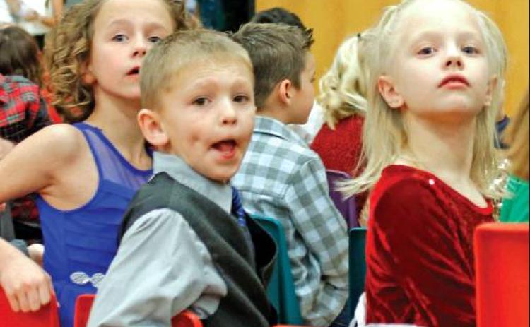 As the children entered the gymnasium they started looking for their loved ones. Pictured left to right are 2nd grade students Kendall Lizakowski, Shawn Patterson, and Nora Hillier. VNV Photo by Lesa Van Camp