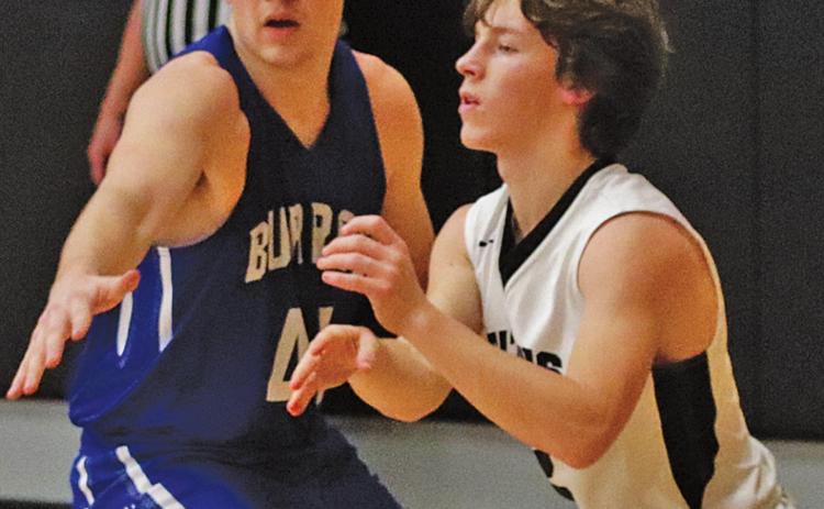 Logan Wieler is guarded by Burro Caden Waterworth last Friday night. VNV photo by Lesa Van Camp