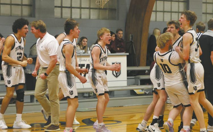 The DVE Titans celebrate following a come-from-behind win over the Langdon Cardinals with a last-minute shot. Photo by Jamie Rarick